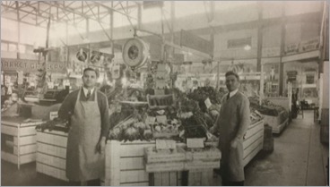 Sacramento Public Market fruit vendors beneath the original exposed steel trusses